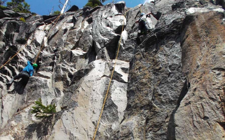 a person wearing safety gear climbs a rock wall